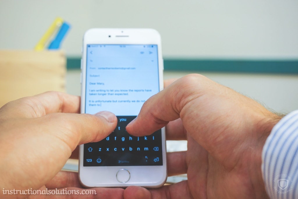 A photo of a student using his smart phone to send a teacher an email introducing himself.